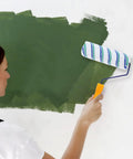 Woman using a Two Piece Seamless Corner Paint Roller With Dual Grip Handles for crisp wall edges while painting.