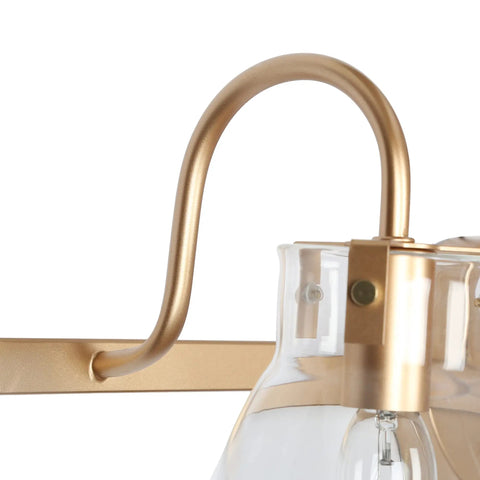 Close-up of Gold Modern Bathroom Vanity Lights Over Mirror With Four Clear Glass Shades bracket detail, minimalist luxury design