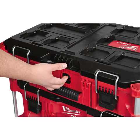Hand holding handle of Packout 22 Inch Tool Box With Heavy Duty Latches And Interior Organizer Trays Durable Modular Storage System
