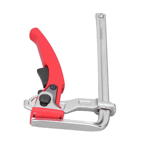 Heavy Duty Ratcheting Table Clamp Hardcore Rail Fixture For Woodworking and Rock Solid Material Stabilization Built With Premium Chrome Steel For Pro Shops close-up view showing red handle and silver metal components.