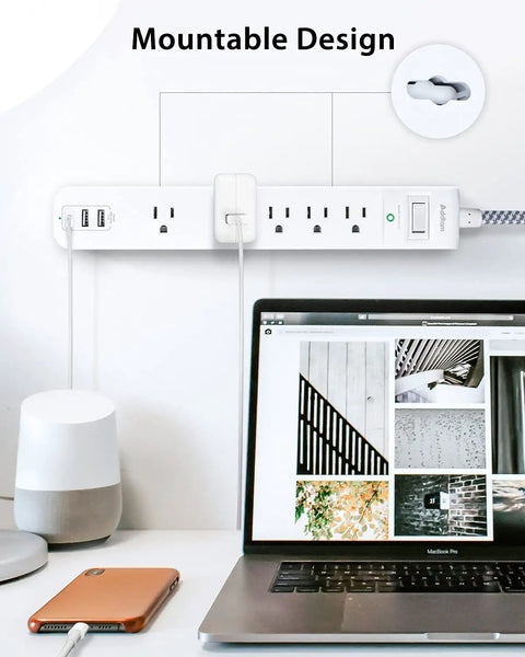 Wall-mounted 10 Ft Power Strip Surge Protector with five outlets, three USB ports, flat plug extension cord, shown in home office setup.