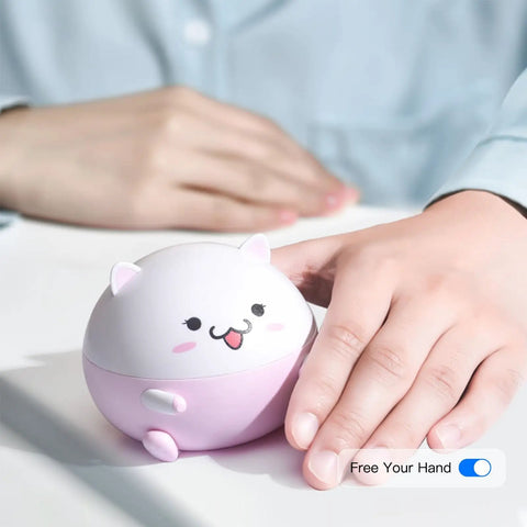 Cute pink and white contact lens cleaning machine shaped like a cat, held by a person, showing "Free Your Hand" text.