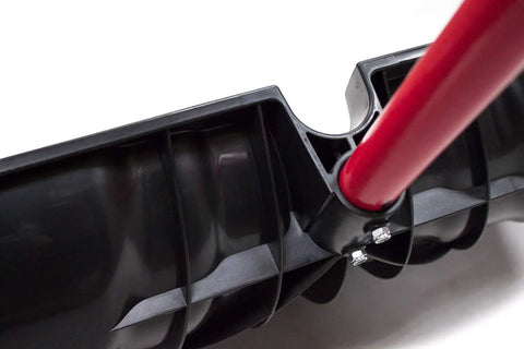 Close-up of the Beast Of A Snow Shovel With Wide Scoop And Fiberglass D-Grip For Driveways, showing red handle and black scoop attachment