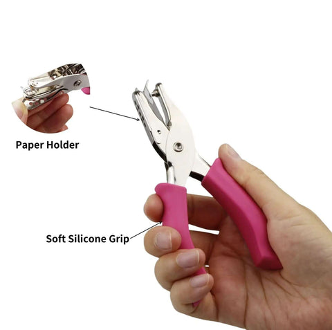 Person holding a Two Pack Handheld Paper Hole Punch Set with pink soft silicone grips showing close-up of paper holder feature.