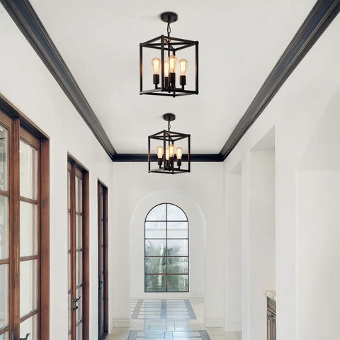 Black 4 Light Lantern Chandelier Farmhouse Vibe Pendant Light With Adjustable Height Rustic Cage fixture in hallway view