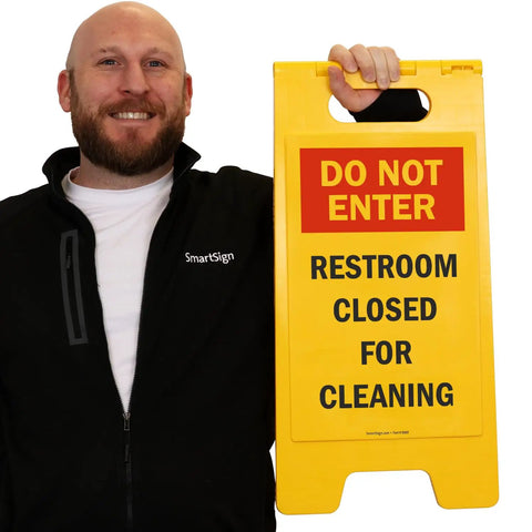 Do Not Enter Restroom Closed For Cleaning Two Sided Folding Floor Sign Plastic Heavy Duty Durable 25 By 12 Inches Red Black Yellow High Visibility Double Sided For Busy Hallways And Maintenance Areas, shown held upright