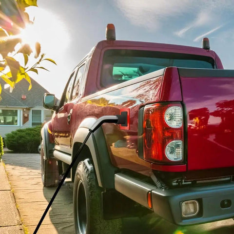 Fake EV Charging Port Magnet Snap On For Diesel Gas ICE Truck Gag Accessory on red truck with sunset background.