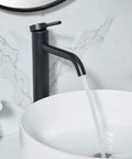 Go-To Matte Black Vessel Sink Faucet Tall And Sleek For 1 Hole Mount 360 Degree Swivel Single Handle Mixer Spout Stainless Steel Bathroom Faucet With Pop Up Drain flowing into a white vessel sink