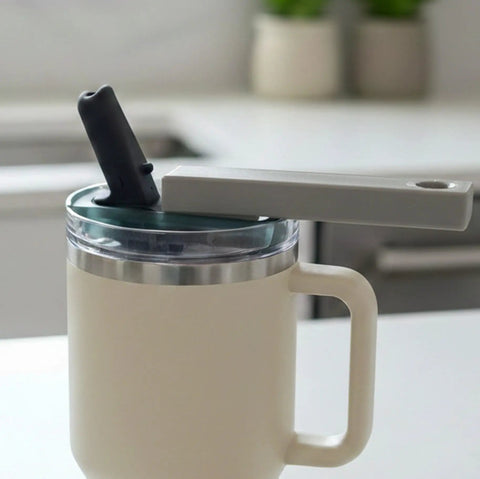 One Hand Tumbler Lid Opener With Ergonomic Lever Universal Fit For 20oz To 40oz Insulated Tumblers Like Stanley Hydrojug And Owala No Fuss Easy Grip Assisted Bottle Opener For Weak Hands Grey in use, shown on a beige insulated tumbler on a kitchen counter.