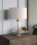 23 Inch Tall Table Lamp With Seeded Glass Shade Polished Nickel Finish And Flax Linen Fabric on wooden nightstand