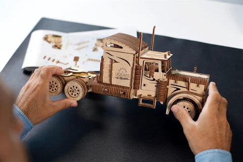 Heavy Duty 6 Cylinder Rubber Band Powered Truck Model Kit 3D Puzzle For Adults Semi Truck Hobby Build Brain Teaser Wooden Mechanical Kit For Home Decor And Collectors wooden semi truck model being assembled by hands