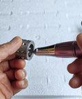 iDili Electric Mini Internal Chamfering Tool Deburring Machine With Diamond Grinding Head for Tiny Holes, hand holding metal part.