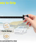 Hand holding transmission dipstick with grip over scenic road, Transmission Dipstick Replacement For 6F24 Automatic Transmissions 10323A 10323B