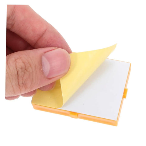 Person's hand peeling back yellow tape from Hella Handy Six Piece Solderless Breadboard Kit for Circuit Prototyping.
