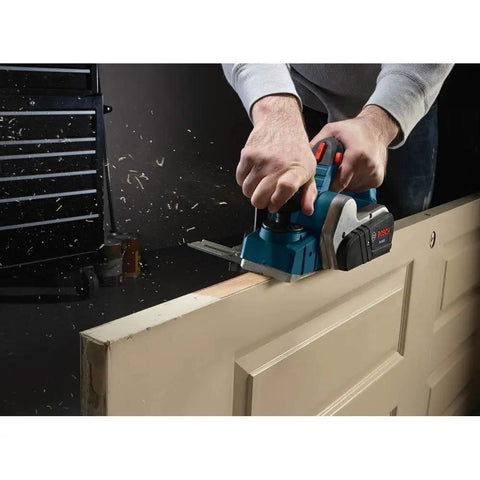 Six And A Half Amp Planer With Aluminum Front And Rear Shoes Three And A Quarter Inch Cutting Width Separate Inch And Metric Depth Scales Ball Joint Cord Swivel For Easy Positioning Factory Reconditioned For A Smooth Accurate Finish in use on a door