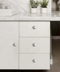 Set Of 4 Hex Cabinet Knobs Made Of Solid Brass With Marble And Gold Cherry Blossom Accents installed on white drawer