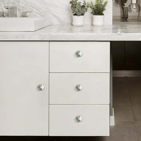 Set Of 4 Hex Cabinet Knobs Made Of Solid Brass With Marble And Gold Cherry Blossom Accents installed on white drawer