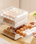 Hands accessing Big Capacity Fridge Egg Organizer With 2 Stackable Clear Trays Holds Up To 32 Eggs Easy Grab Handles