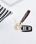 Dope And Totally Legit Premium Leather Wristlet Keychain Featuring Sparkling Crystal Diamonds And Classy Craft Pearls with keys on a surface.