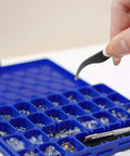 Complete Eyeglass Repair Kit With 1000 PCS In 32 Slot Blue Case featuring tweezers selecting a rust-proof screw.