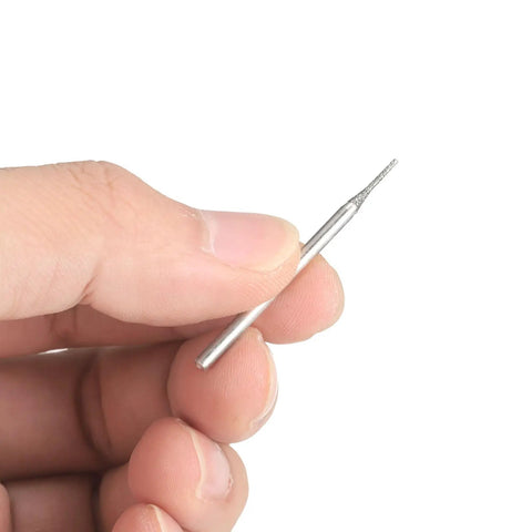 Person holding a bit from the 20 Piece Diamond Hole Saw Bits Set With Cylindrical Head 80 Grit For Gems Glass Jade Emerald 1 Millimeter Diameter