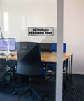 Aluminum Door Sign 9x3 Inches Self Adhesive Waterproof Office Sign For Authorized Personnel Only on glass wall in office.