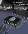 Plug And Play 95W PoE Plus Injector Gigabit Network Power Adapter on a table next to a smartphone with ethernet ports shown.