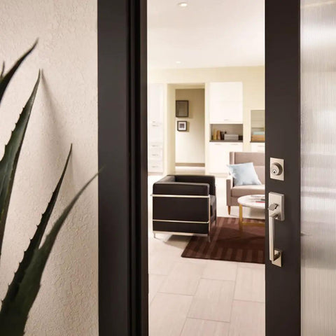 Century Single Cylinder Door Handleset With Elan Lever Satin Chrome Finish installed on exterior door, modern interior view