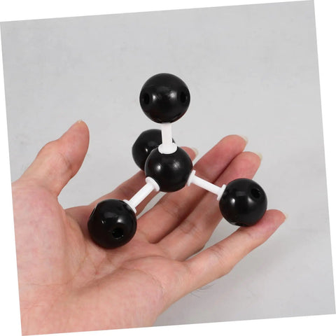 Hands On Molecular Model Kit For Chemistry Education Classroom Science Teaching Tool Build Realistic Molecular Structures. Hand holding small black and white plastic model.