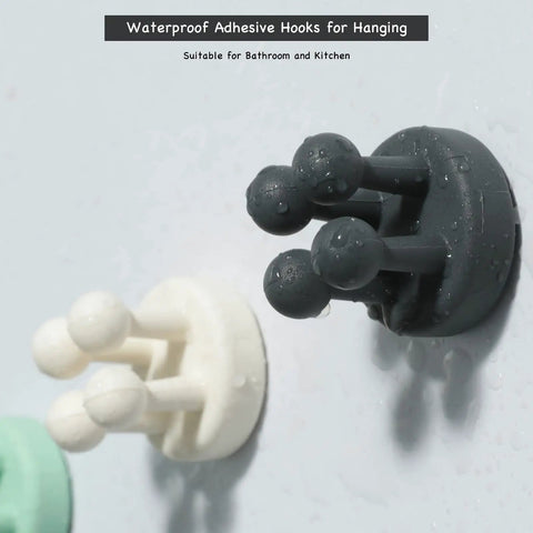 Three waterproof silicone holders on wall, part of Four Pack Self Adhesive Silicone Toothbrush Holders Wall Mounted Mirror Hooks.