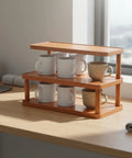 Clean 3 Tier Bamboo Cup Organizer Rack And Sharp Countertop Mug Stand For Coffee Bar Kitchen Office Storage Shelf With 6 Grid Wood Holder Setup Vibe displaying mugs on a wooden desktop