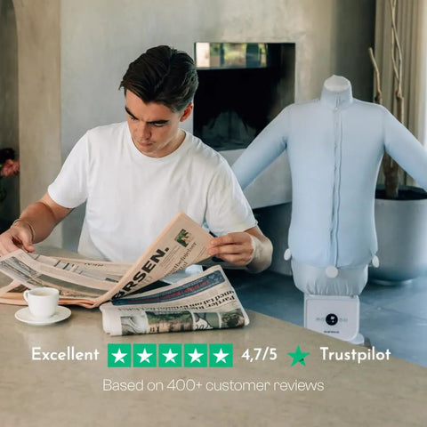 Man reads newspaper next to Automatic Ironing Machine 4.0 for Home Use, Hands Free Wrinkle Remover and Clothes Dryer with shirt form.