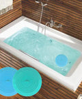 Slick Silicone Tub Stopper Two Pack, 5 Inch Flat Suction Bath Plug With Heavy Grip, Catches Every Stray Hair And Stops Water Drips No Leak Nonsense For Bathtubs And Sinks, Blue And Green Kit displayed in bathtub with water.