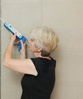 Person applying Ultimate 100 Percent Silicone Sealant For Kitchen And Bath, Waterproof, Low Odor, Clear Caulk on tile