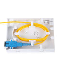 PNGKNYOCN 2-port fiber optic terminal junction box with blue SC/UPC connector and yellow fiber on white desktop panel