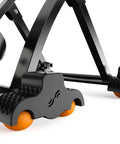 Rocker Feet Adapters for Indoor Cycling Trainers, 4 Pack with 8 Squash Balls, black with orange balls, close-up view