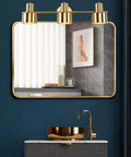 Dope Brushed Brass Vanity Light Fixture With 3 Lights mounted over a mirror in a modern bathroom setting, IP44 waterproof.