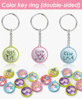 Colorful key rings with messages from 50 Pack Keychain Button Making Kit For 1.25 Inch Button Makers, 32mm Refills displayed