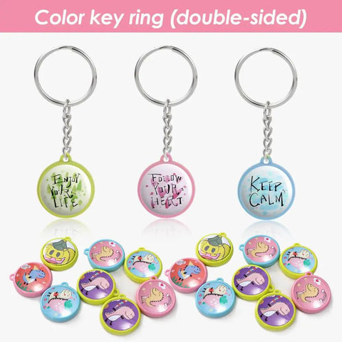 Colorful key rings with messages from 50 Pack Keychain Button Making Kit For 1.25 Inch Button Makers, 32mm Refills displayed