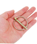 8 Piece Heavy Duty Lynch Pin Assortment Kit For Farm Gear With Spring Loaded Safety Pins For Trucks Trailers ATVs Tractors Lawn Mowers And More For All Your Projects; single steel pin in hand