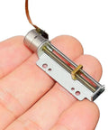 Mini Stepper Motor Linear Actuator With Eight Millimeter Precision Screw And Metal Block Nut Two Phase Four Wire Thirty Millimeter Stroke held in hand.
