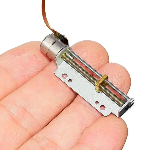 8mm Precision Stepper Motor With 2 Phase 4 Wire Linear Actuator And Metal Block Nut shown in hand for scale and detail.