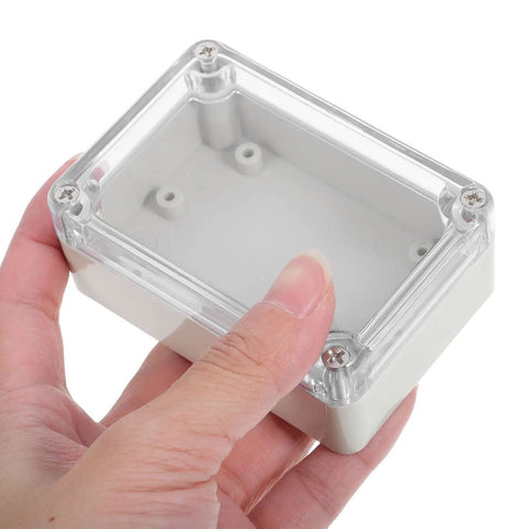 Hand holding a transparent ABS lid of a Top-Tier Waterproof Electrical Box Set For Outdoor Security Modules.