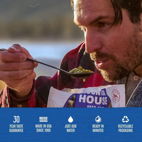 Man enjoying Buffalo Style Chicken Mac And Cheese Freeze Dried Camping Meal With 12 Servings And 30 Year Shelf Life outdoors