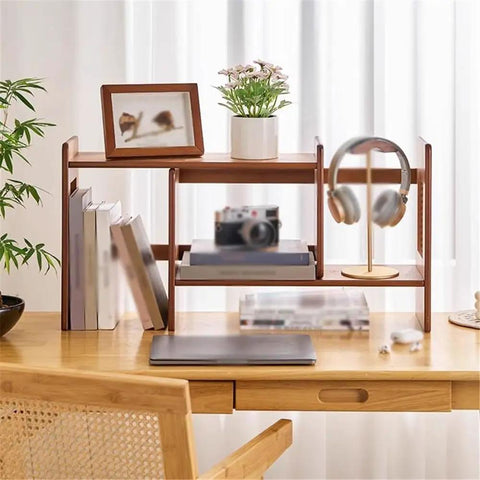 Expandable Bamboo Bookshelf Organizer For Your Home Office on desktop with books, frame, and headphones