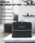 Front view of a black Creality tool kit wrap case with blue logo and carrying handle on a white table.