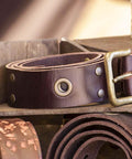 Brown leather belt with metal buckle and rivet details showcasing products made with Leather Rivet Kit With 480 Sets In 3 Sizes And 4 Colors.
