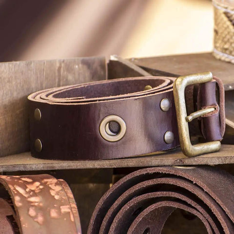 Brown leather belt with metal buckle and rivet details showcasing products made with Leather Rivet Kit With 480 Sets In 3 Sizes And 4 Colors.