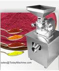 Heavy Duty Spice Grinder For Dry Foods And Pepper Powder Grinding Machine Built With Stainless Steel And Carbon Steel For Tough Long Lasting Performance A Universal Grinder That Handles Spices Grains Coffee Beans And More In Home Kitchens next to colorful ground spices.