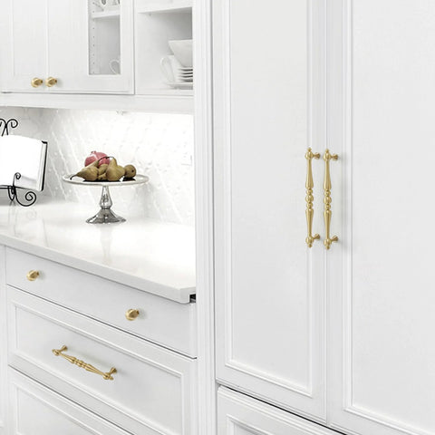 Two Pack 5 Inch Center Solid Brass Cabinet Pulls In Vintage Gold Brushed Finish installed on white kitchen cabinets